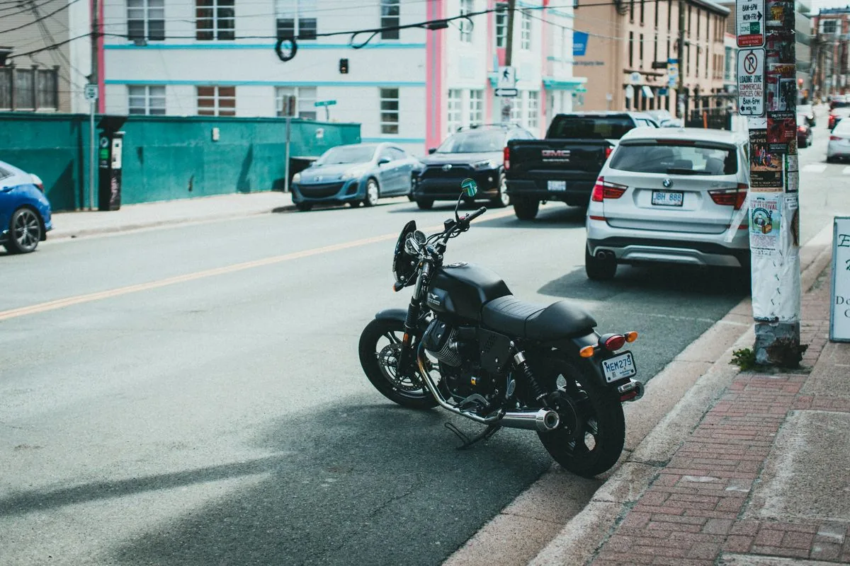 Motorcycle parked at the curb on a busy city street